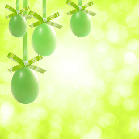 Holiday card with green easter eggs hang on ribbon and place for your textの写真素材
