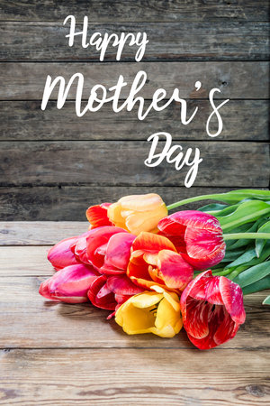 Holiday greetings card with tulip flowers and hand lettering text Happy Mothers Dayの写真素材
