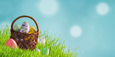 Holiday card with colorful Easter eggs in basket and place for your textの写真素材