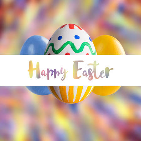 Holiday card with colorful painted eggs and Happy Easter lettering text on white frameの写真素材