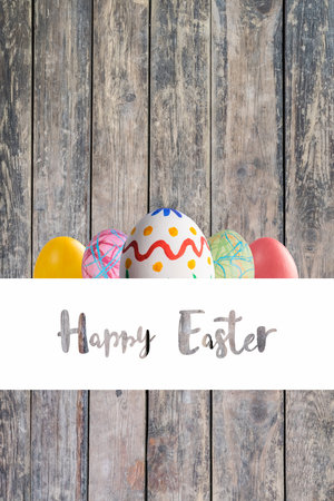 Holiday card with colorful painted eggs and Happy Easter lettering text on white frameの写真素材