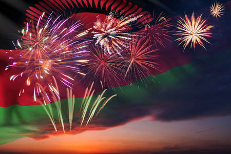 Holiday night sky with fireworks and flag of Malawi for Independence dayの写真素材