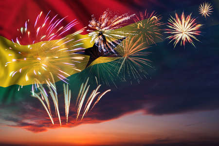 Majestic fireworks in evening skyHoliday night sky with fireworks and flag of Ghana for Independence dayの写真素材
