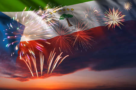 Majestic fireworks in evening skyHoliday night sky with fireworks and flag of Equatorial Guinea for Independence dayの写真素材
