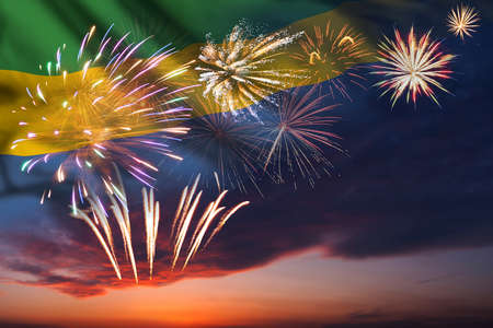 Majestic fireworks in evening skyHoliday night sky with fireworks and flag of Gabon for Independence dayの写真素材