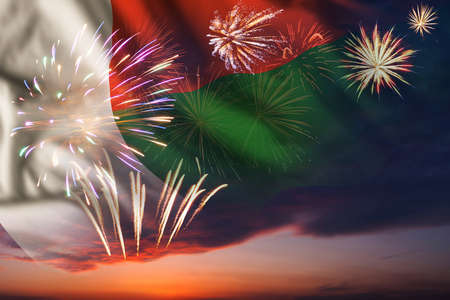 Majestic fireworks in evening skyHoliday night sky with fireworks and flag of Madagascar for Independence dayの写真素材