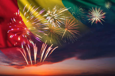 Majestic fireworks in evening skyHoliday night sky with fireworks and flag of Guinea for Independence dayの写真素材