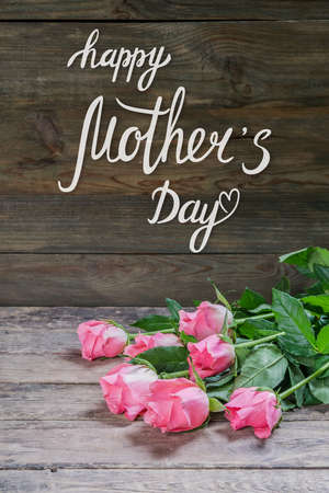 Holiday greetings card with rose flowers and hand lettering text Happy Mothers Dayの写真素材