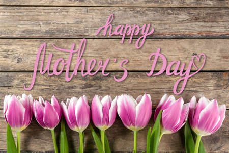 Holiday greetings card with tulip flowers and hand lettering text Happy Mothers Dayの写真素材