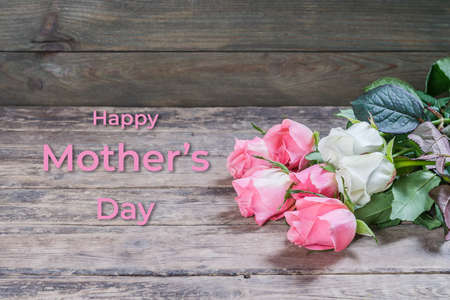 Holiday greetings card with rose flowers and hand lettering text Happy Mothers Dayの写真素材