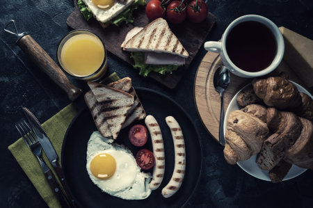 Fried sausage with eggs and vegetables on pan.の写真素材