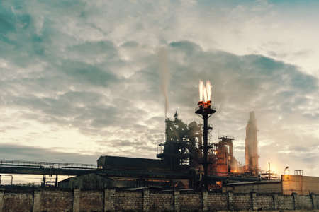 Vintage landscape of toxic chemical plant with pipes and smoke, with lights and smoke, long exposureの写真素材