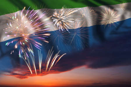 Majestic fireworks in evening sky Holiday night sky with fireworks and flag of Sierra Leone for Independence dayの写真素材