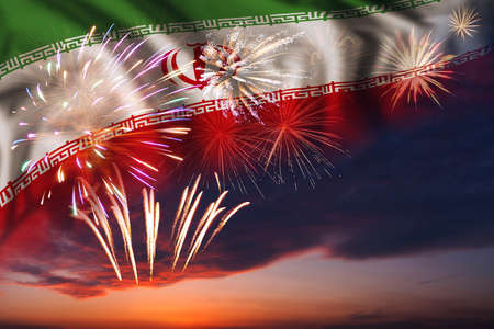Majestic fireworks in evening sky Holiday night sky with fireworks and flag of Iran for Independence dayの写真素材