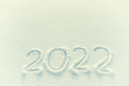 2022 holiday text draw on snow for New Year and Christmas card, place for your text. Retro stylization, vintage film filterの写真素材