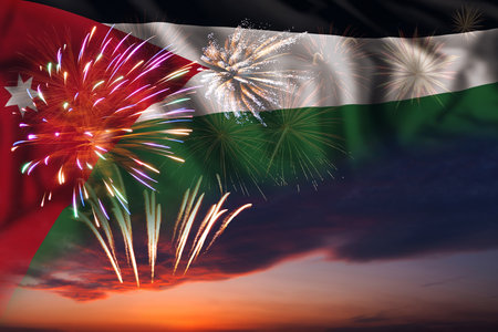 Majestic fireworks in evening sky Holiday night sky with fireworks and flag of Jordan for Independence dayの写真素材
