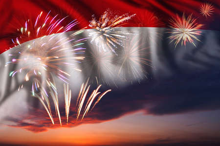 Majestic fireworks in evening sky Holiday night sky with fireworks and flag of Indonesia for Independence dayの写真素材