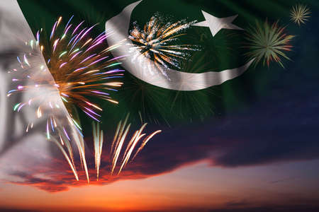 Majestic fireworks in evening sky and flag of Pakistan for Independence dayの写真素材