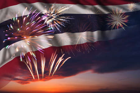 Majestic fireworks in evening sky and flag of Thailand for Independence day or National Holidayの写真素材