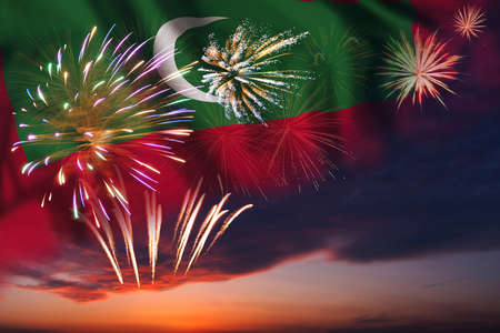 Majestic fireworks in evening sky and flag of Maldives for Independence dayの写真素材