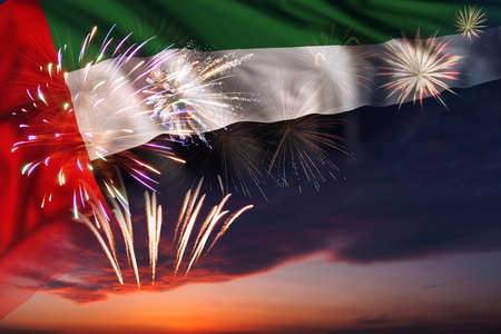 Majestic fireworks in evening sky and flag of United Arab Emirates for Independence day or National Holidayの写真素材