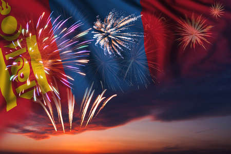 Majestic fireworks in evening sky and flag of Mongolia for Independence dayの写真素材