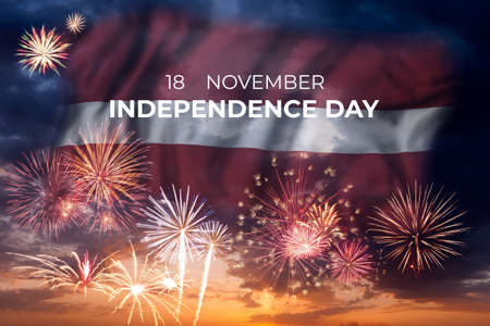 Holiday sky with fireworks and flag of Latvia of Independence dayの写真素材