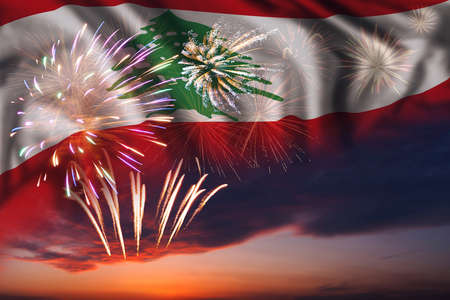 Majestic fireworks in evening sky and flag of Lebanon for Independence dayの写真素材