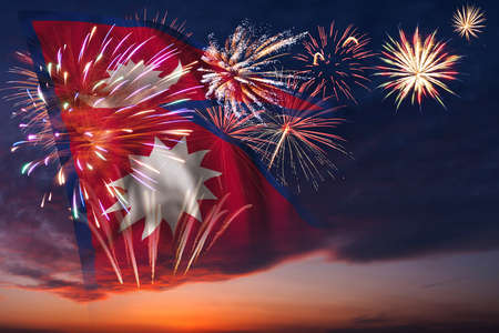 Majestic fireworks in evening sky and flag of Nepal for Independence dayの写真素材