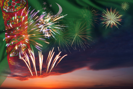 Majestic fireworks in evening sky and flag of Turkmenistan for Independence day or National Holidayの写真素材