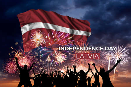 Holiday sky with fireworks and flag of Latvia of Independence dayの写真素材
