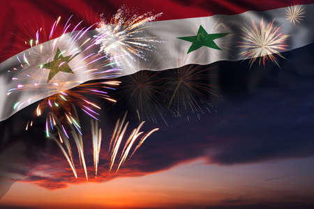 Majestic fireworks in evening sky and flag of Syria for Independence day or National Holidayの写真素材