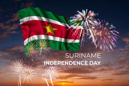 Holiday sky with fireworks and flag of Suriname of Independence dayの写真素材