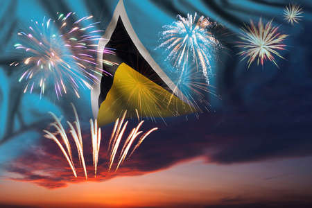 Majestic fireworks in evening sky and flag of Saint Lucia for Independence day or National Holidayの写真素材
