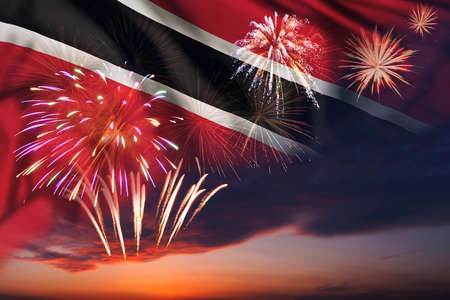 Majestic fireworks in evening sky and flag of Trinidad and Tobago for Independence day or National Holidayの写真素材