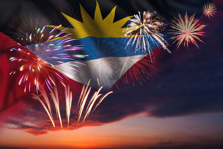 Majestic fireworks in evening sky and flag of Antigua and Barbuda for Independence day or National Holidayの写真素材