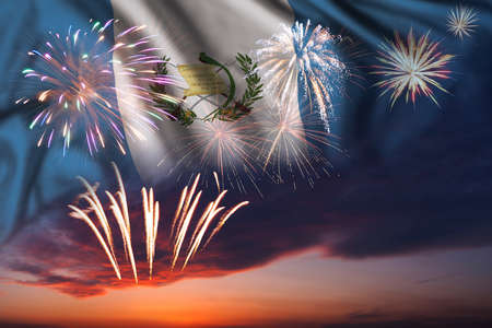 Majestic fireworks in evening sky and flag of Guatemala for Independence day or National Holidayの写真素材