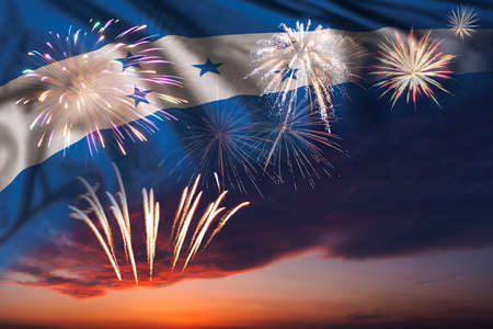Majestic fireworks in evening sky and flag of Honduras for Independence day or National Holidayの写真素材