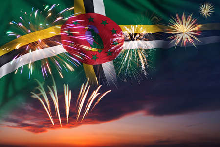 Majestic fireworks in evening sky and flag of Dominica for Independence day or National Holidayの写真素材