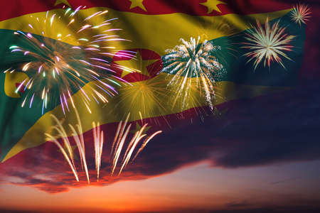 Majestic fireworks in evening sky and flag of Grenada for Independence day or National Holidayの写真素材