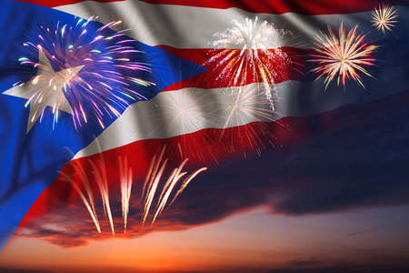 Majestic fireworks in evening sky and flag of Puerto Rico for Independence day or National Holidayの写真素材