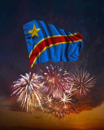 Holiday fireworks in evening sky and flag of Congo for National Independence dayの写真素材