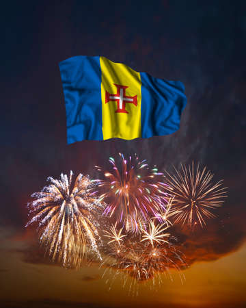 Holiday fireworks in evening sky and flag of Madeira for National Independence dayの写真素材