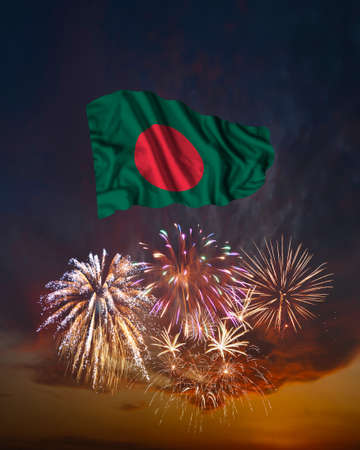 Holiday fireworks in evening sky and flag of Bangladesh for National Independence dayの写真素材