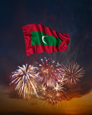 Holiday fireworks in evening sky and flag of Maldives for National Independence dayの写真素材