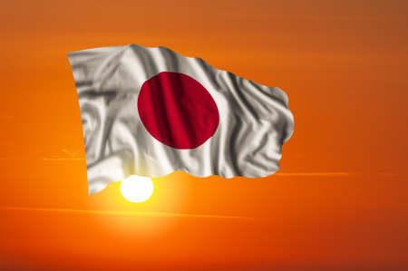 Evening sky with majestic fireworks and flag of Japan on National holidayの写真素材