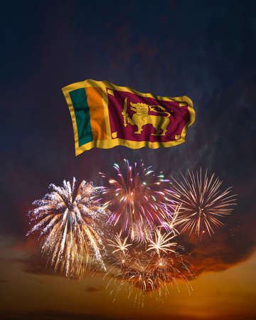 Holiday fireworks in evening sky and flag of Sri Lanka for National Independence dayの写真素材