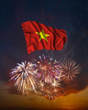 Holiday fireworks in evening sky and flag of Vietnam for National Independence dayの写真素材