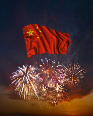 Holiday fireworks in evening sky and flag of Republic of China for National Independence dayの写真素材
