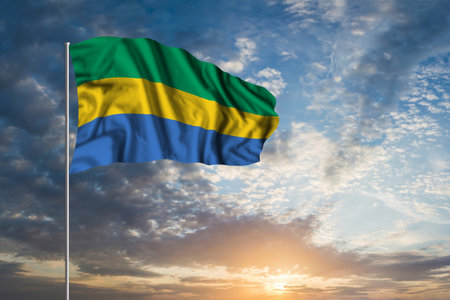 Waving National flag of Gabon in beautiful skyの写真素材